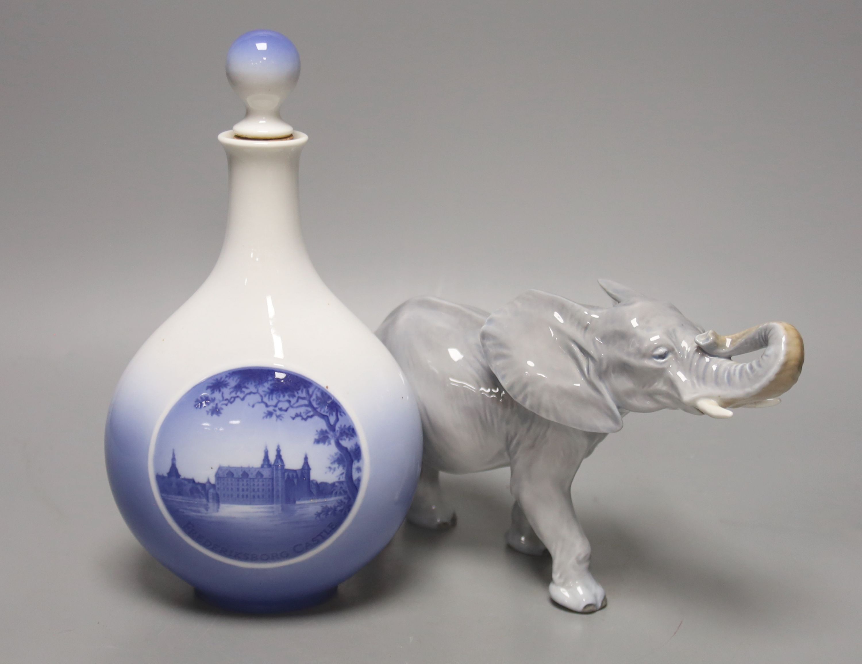 A Royal Copenhagen bottle and stopper and a model of an elephant, bottle and stopper 25 cms high.